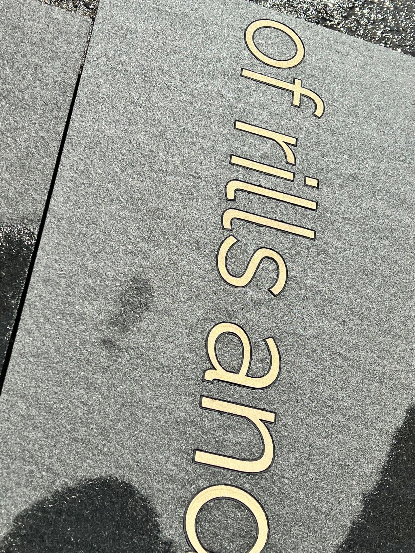 Brass text in granite paving
