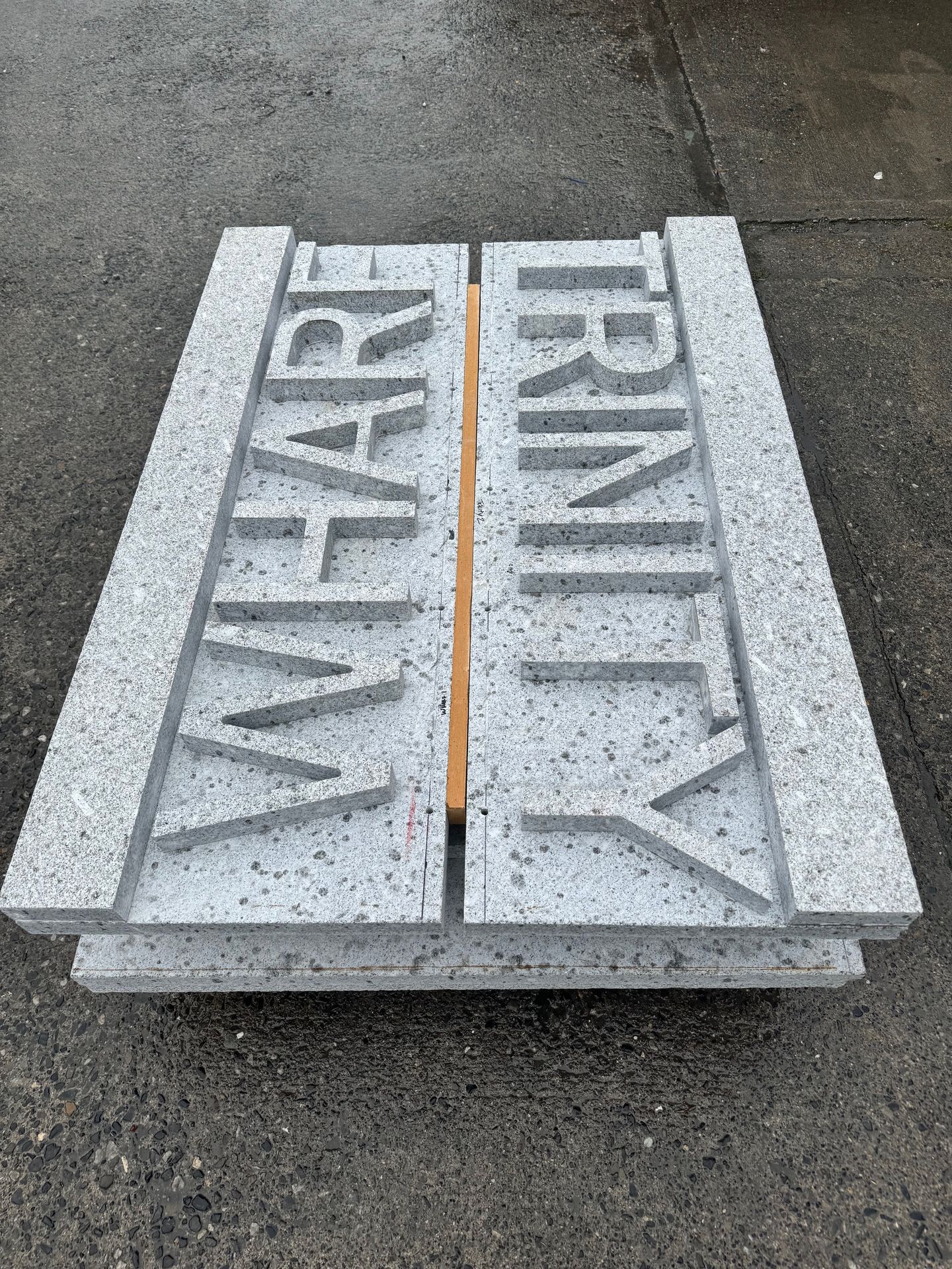 “CNC-cut granite letters for Trinity Wharf entrance signage”