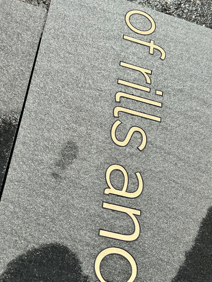 Brass text in granite paving